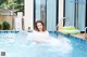 A woman in a swimming pool with an inflatable ring.