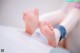 A close up of a person's feet on a bed.