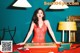 A woman in a red dress sitting at a table.